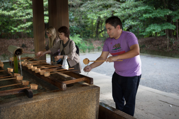 Andrew doing a hand-washing ritual at a Shinto temple